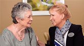 elderly woman and professional discussing alzheimers