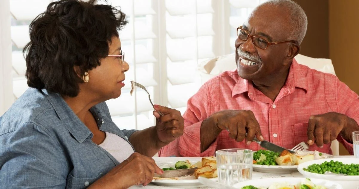 Senior couple eating a healthy dinner together.