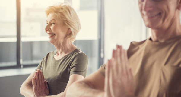 Two seniors at The Bristal Assisted Living practicing yoga