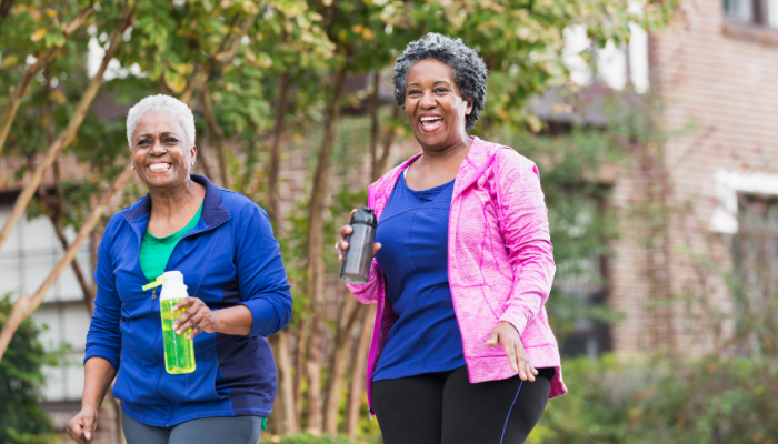 Two mature women going for a walk in bright colors.
