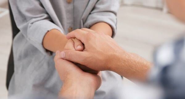 Gentleman comforting an elderly woman.