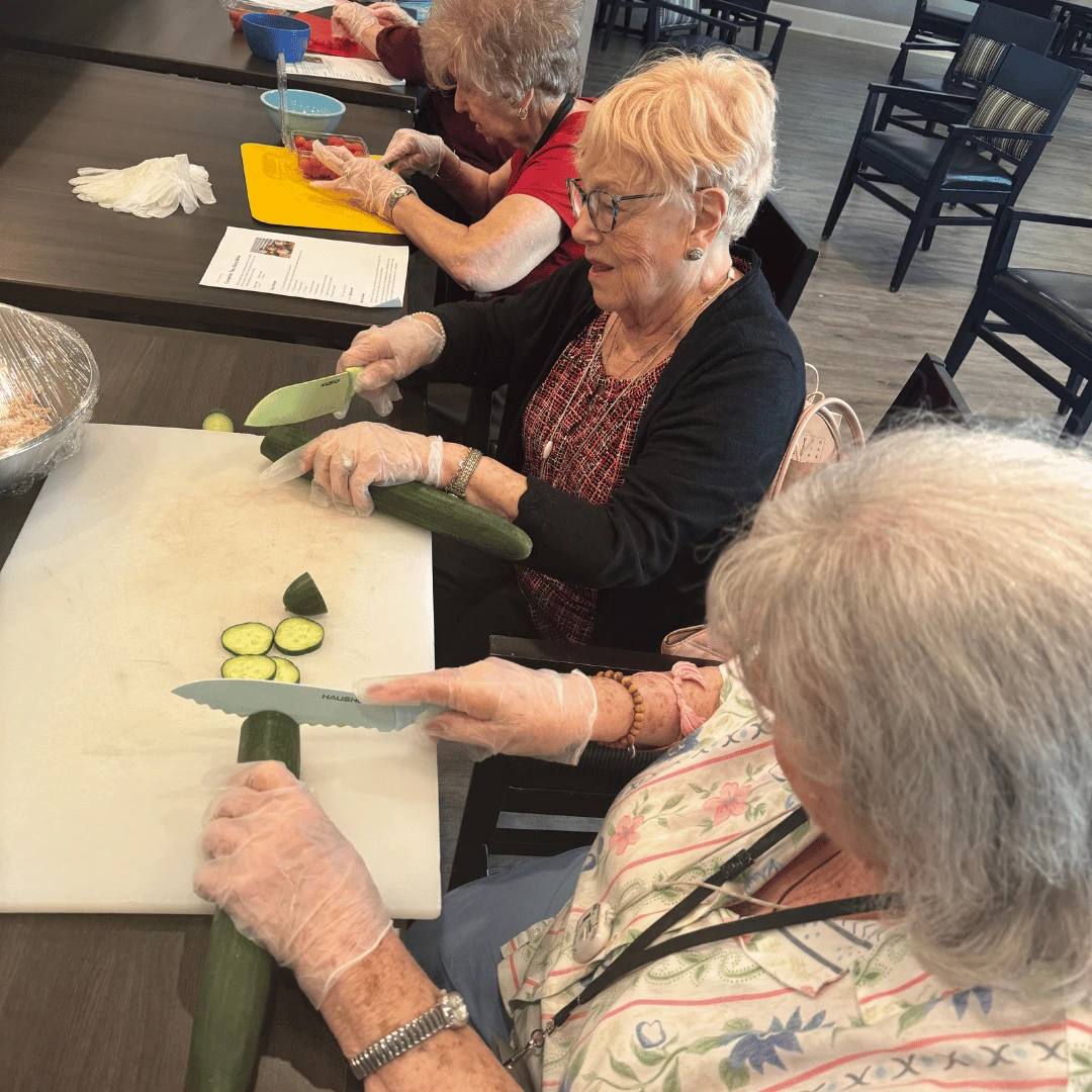 Members of the Food Prep Club at The Bristal at Wayne enjoy working together to create a snack for everyone to enjoy.