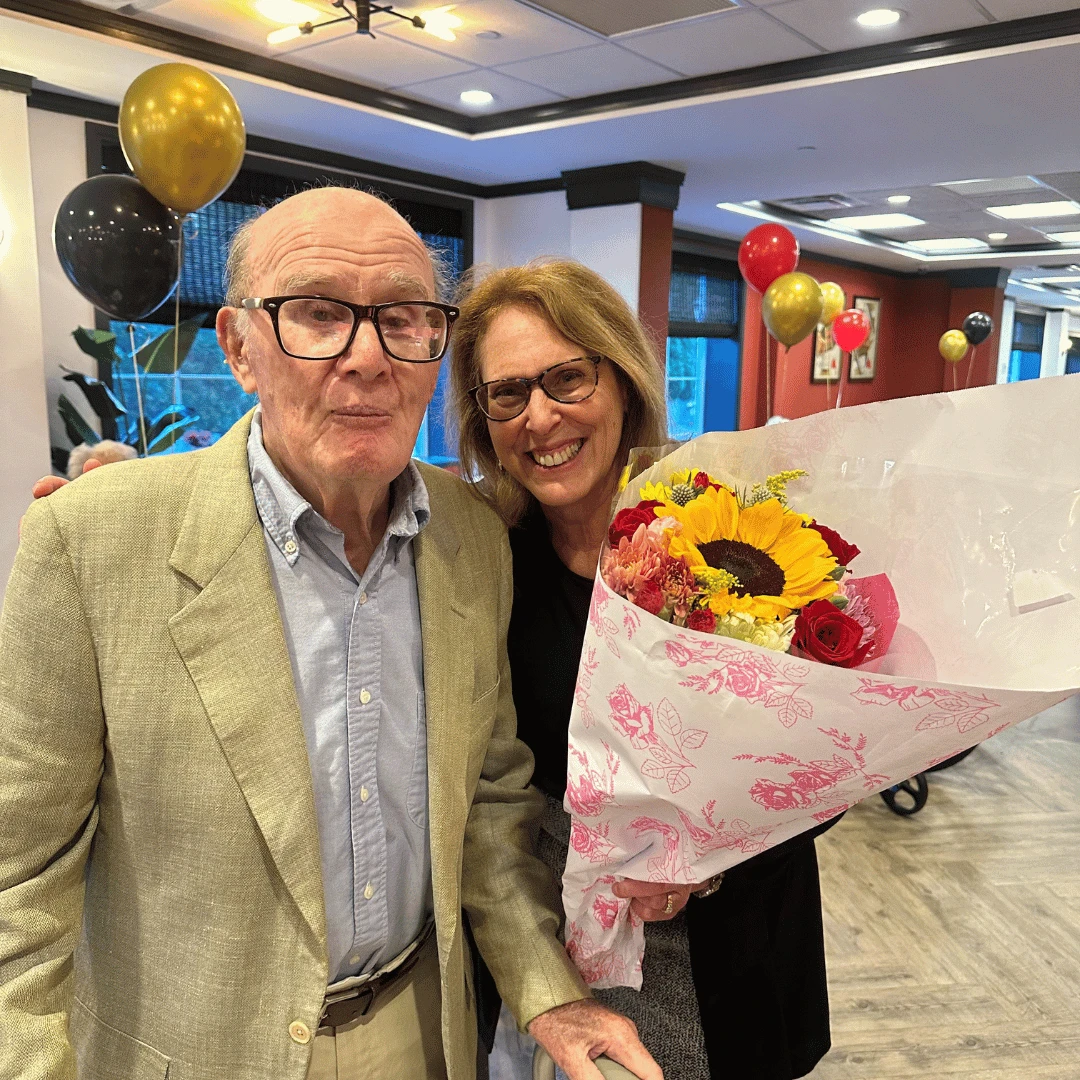 Terry posed for pictures after accepting a beautiful bouquet of flowers at the premier party to celebrate The Instigators release.