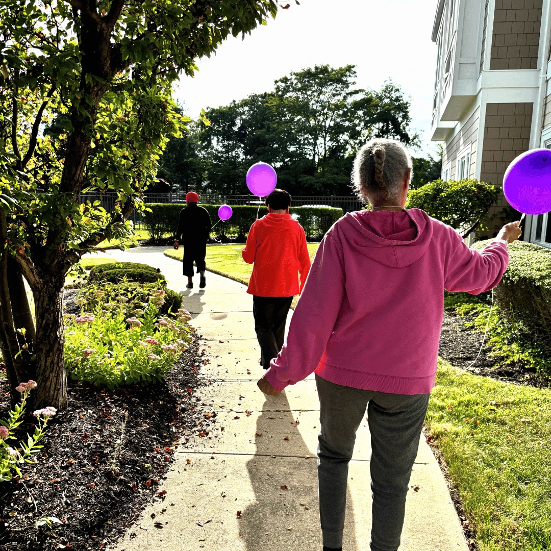 Residents, family and team members of The Bristal Assisted Living participated in the Walk to End Alzheimer's while holding purple balloons symbolic of the cause.