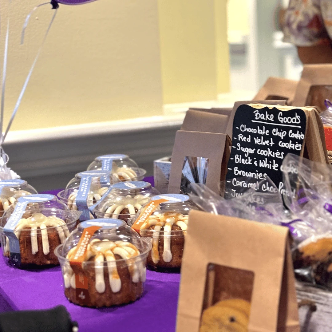 Baked goods for sale for charity were donated by directors of The Bristal were displayed on a purple table cloth.