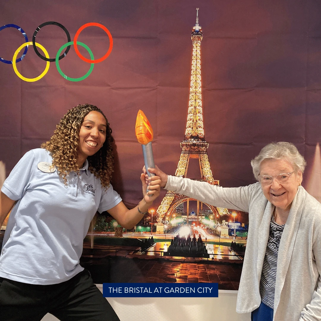 Residents and team members at The Bristal at Garden City posed with a torch in front of the Eiffel tower to cheer for gold!