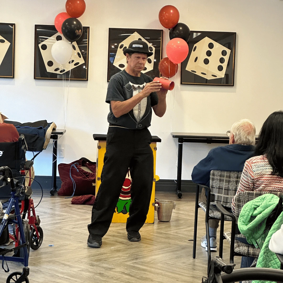 A magician delighted residents and their family during social hour for Grandparents Day.