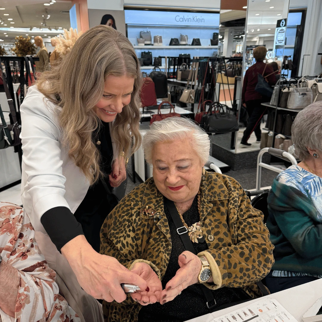 The Clinique professional shares sample product with a resident of The Bristal Assisted Living