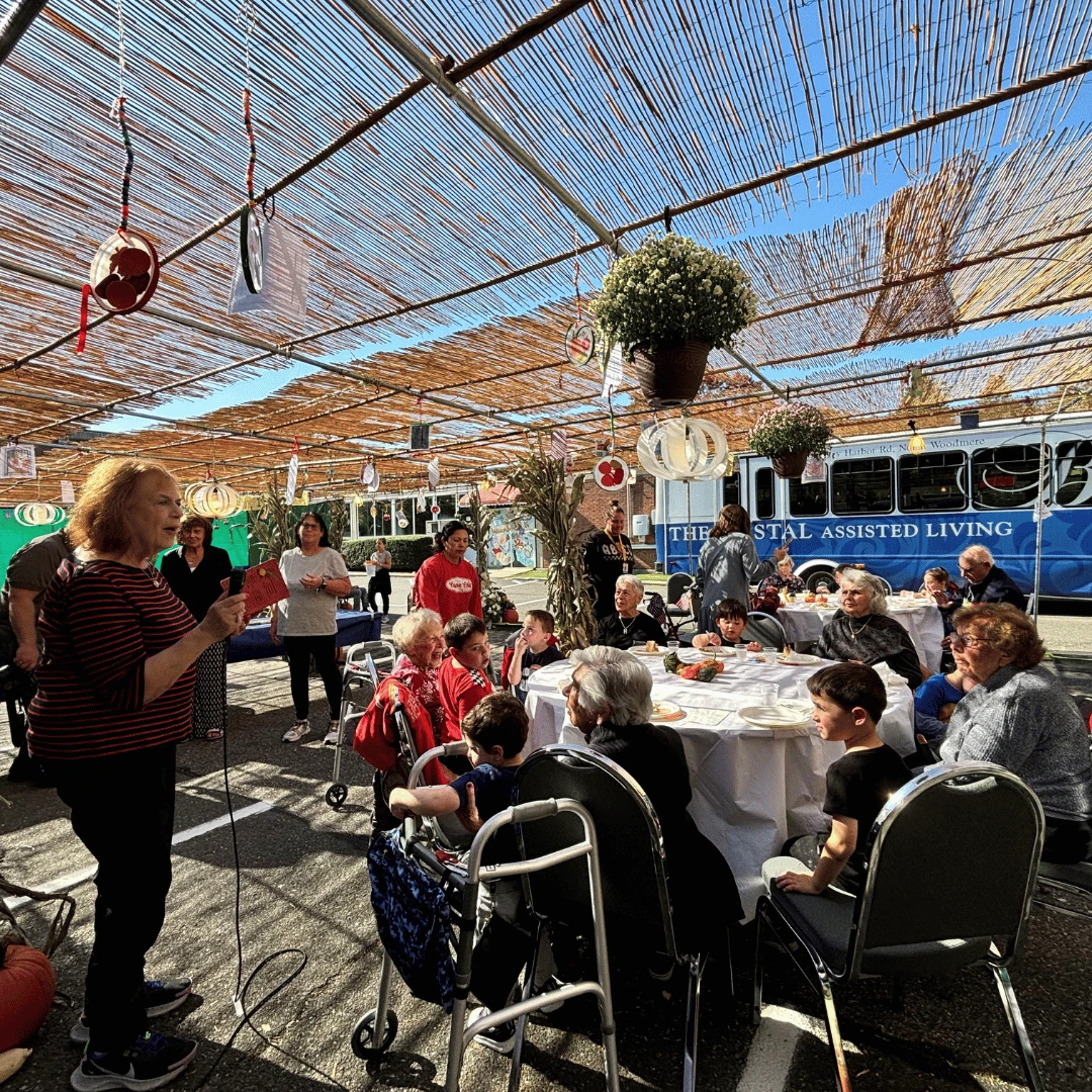 Resident reads a story to the assembled group of residents and preschool children