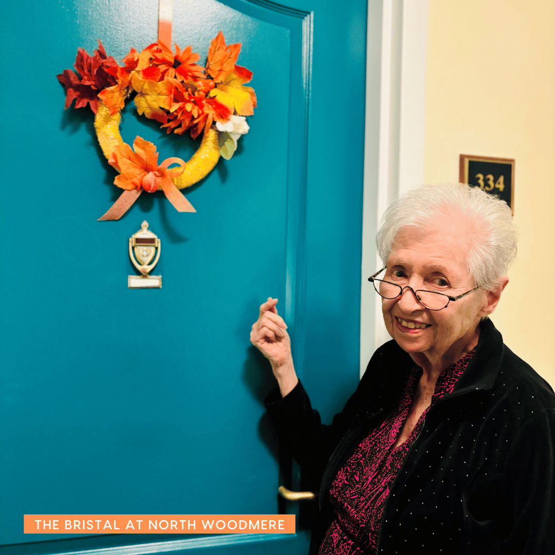 Senior resident from North Woodmere shows off her leafy fall wreath.