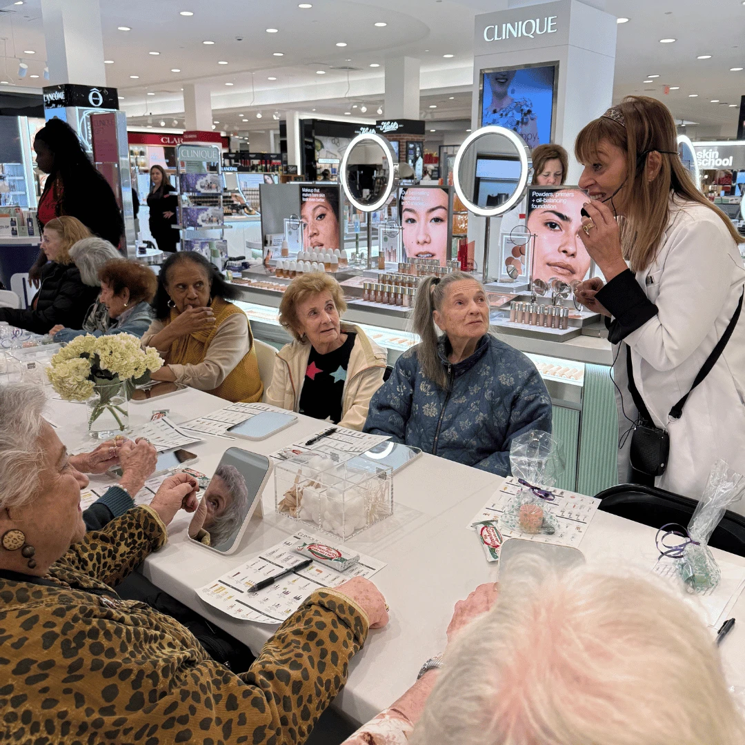 Residnets of The Bristal at Englewood listen to a demonstration by a Clinique skin care expert.