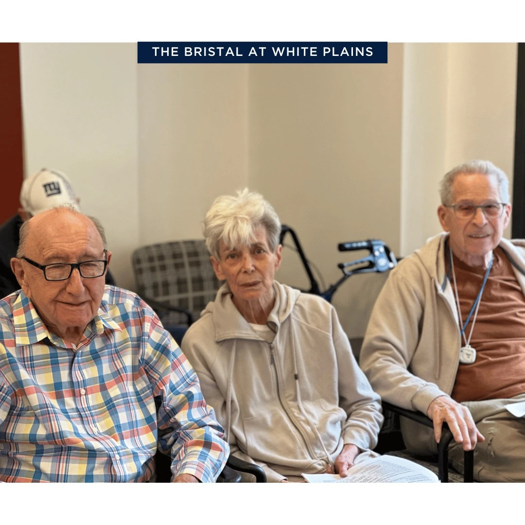 Senior Residents sit together at The Bristal at White Plains to celebrate the new year