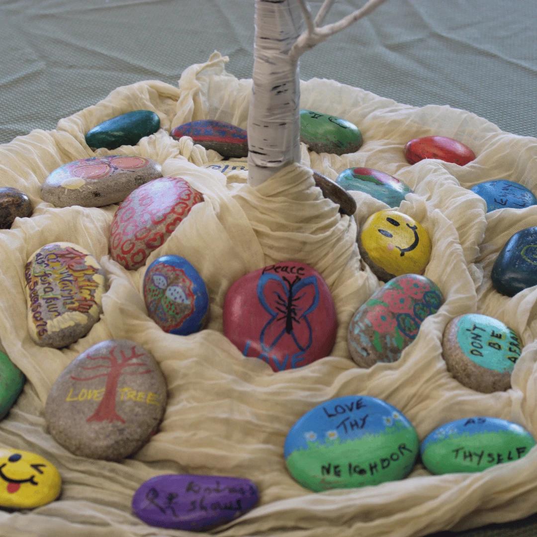 Close up of the rocks with inspiring messages and images created by Lynbrook residents in celebration of World Kindness Day