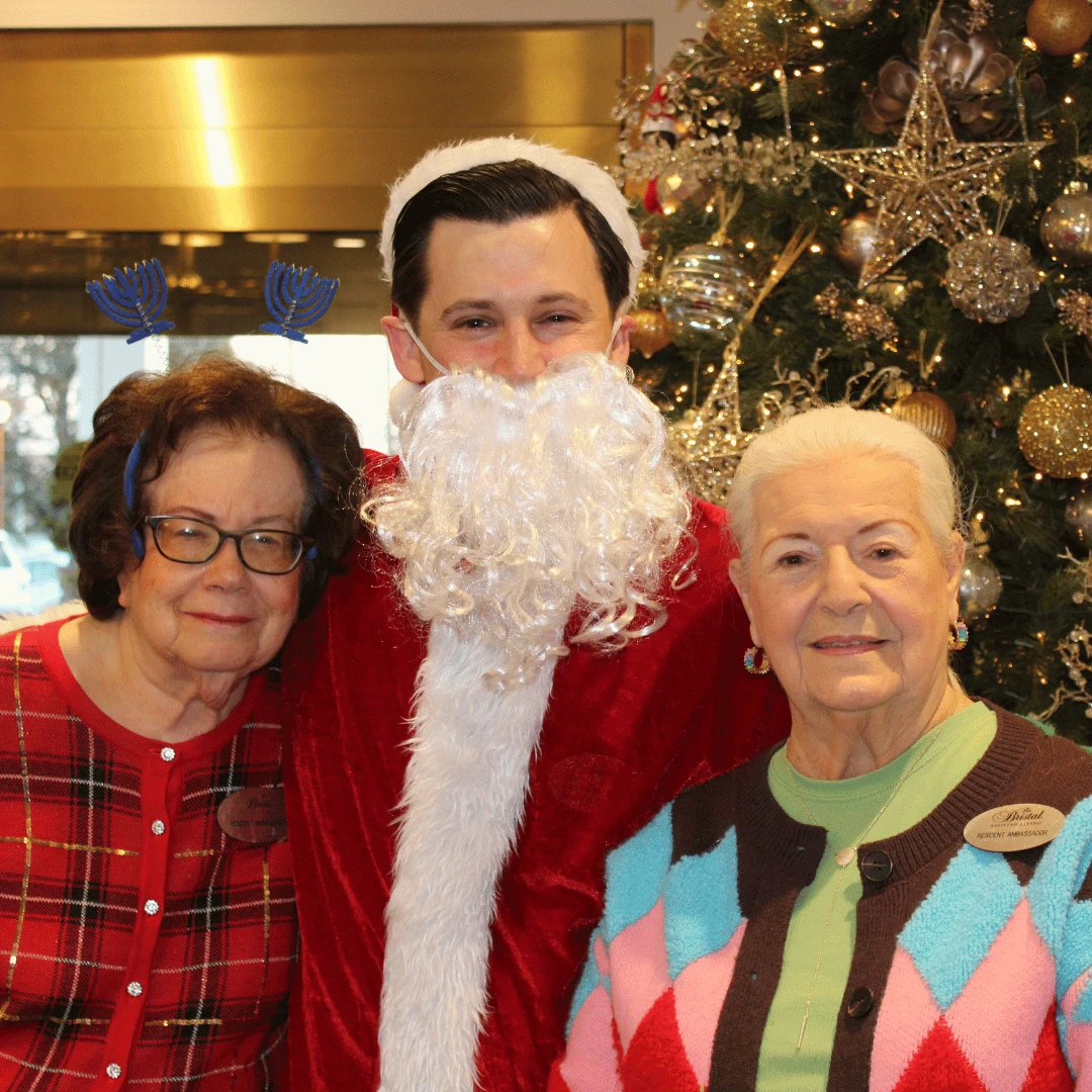 residents pose with Santa in front of the beautiful tree after it had been lit