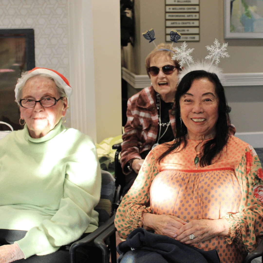 residents and team member at Jericho adorned with festive toppers
