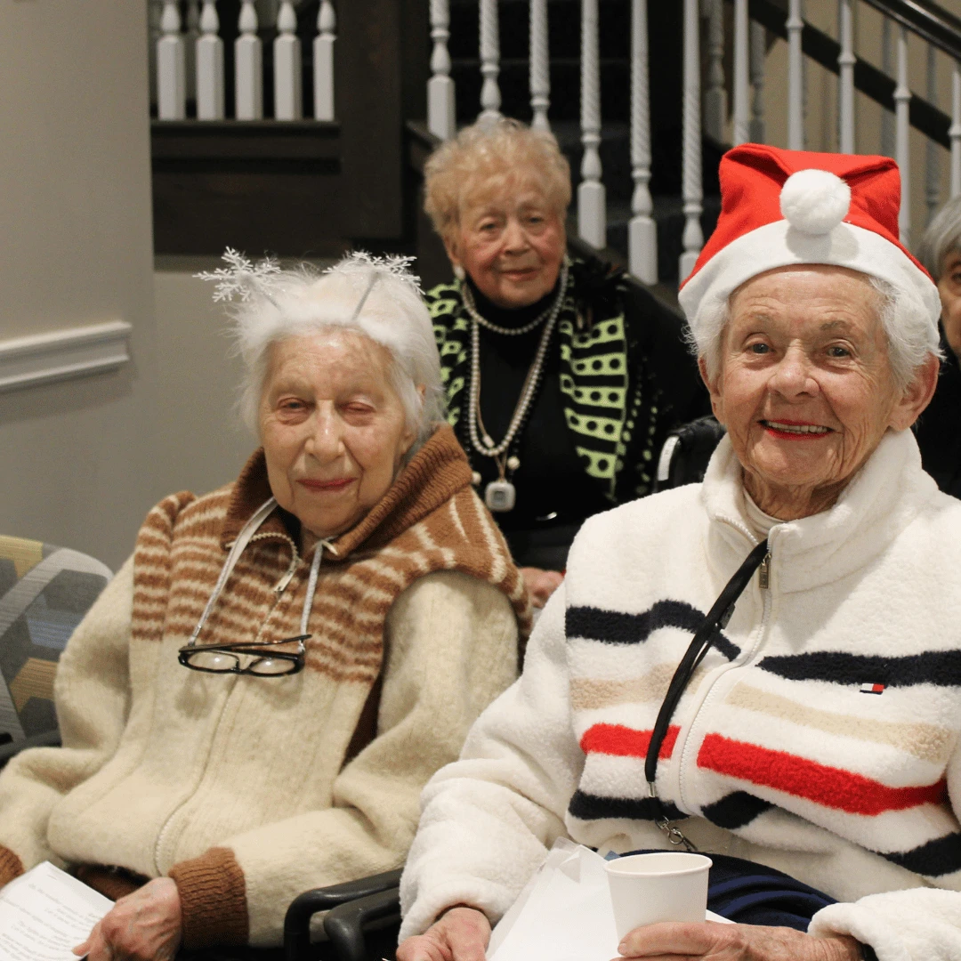 residents posed for pictures at the tree lighting ceremony in Jericho wearing festive holiday gear