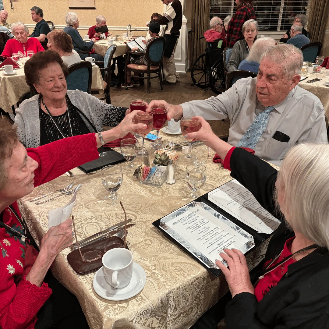 Residents raise a glass in celebration of the holidays at The Bristal at Holtsville.