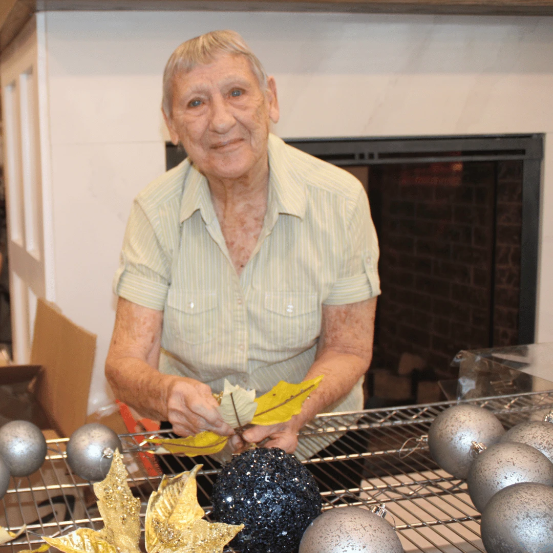 Resident of Somerset prepares golden ornaments for the tree trimming celebration.