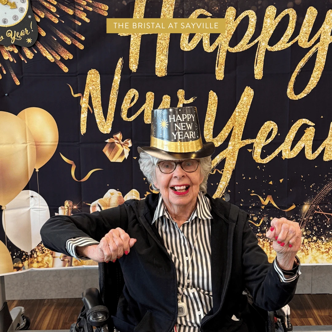 Sayville resident wears festive attire and poses for a picture in front of a New Years backdrop