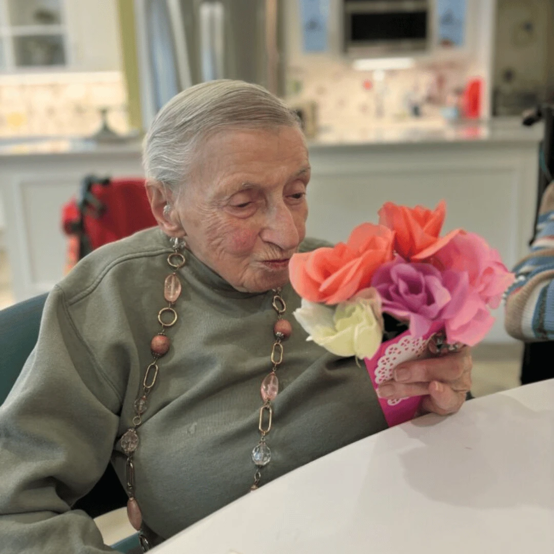 Bethpage resident admiring a bouquet she created