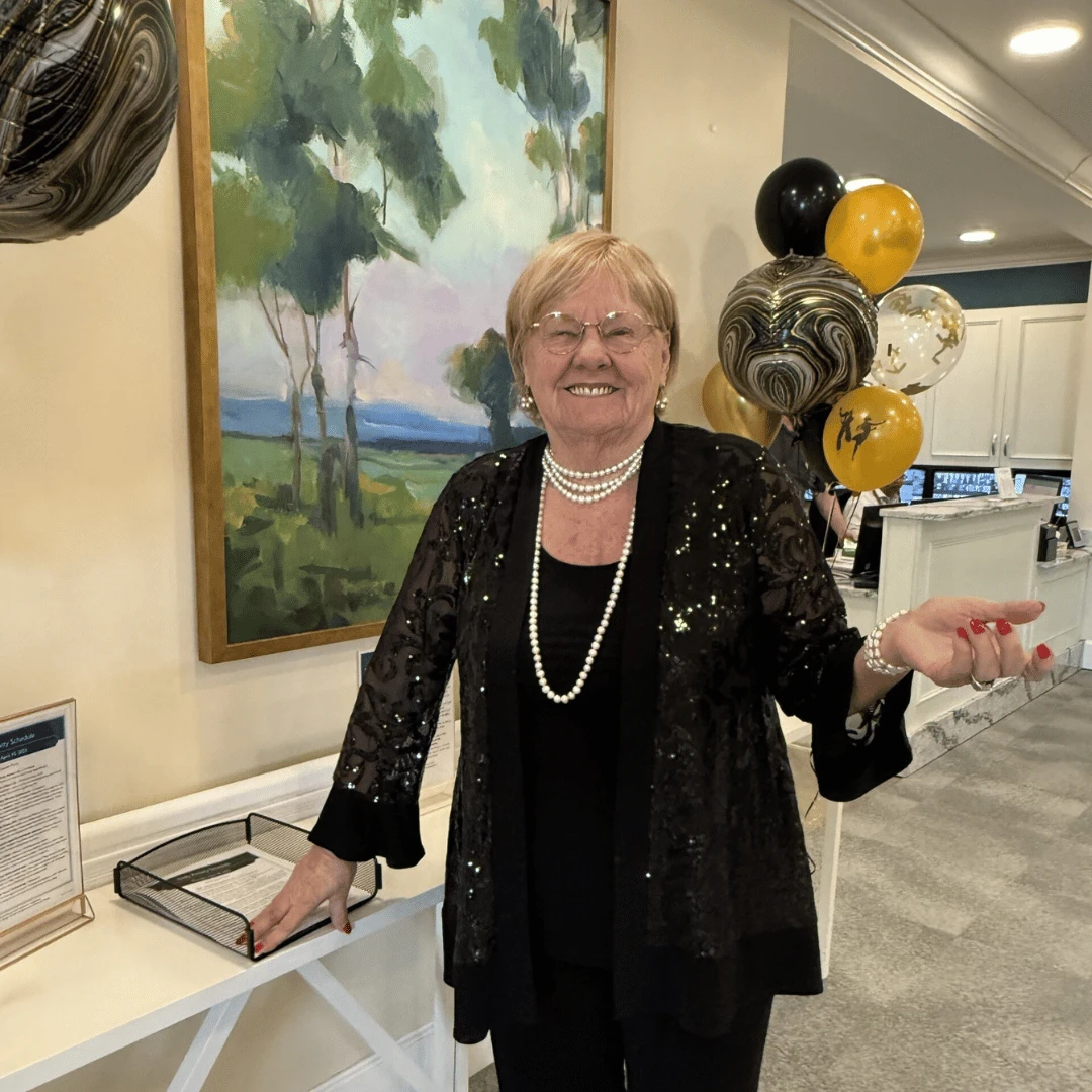 An elegant resident dressed in her black formal attire and long, white strand of pearls