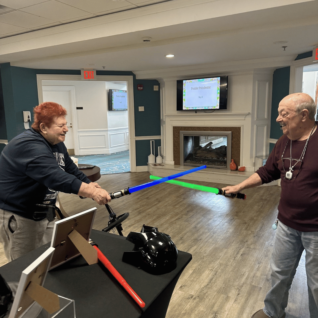 Two residents at The Bristal at Westbury duel with Lightsabers after discussing Star Wars 