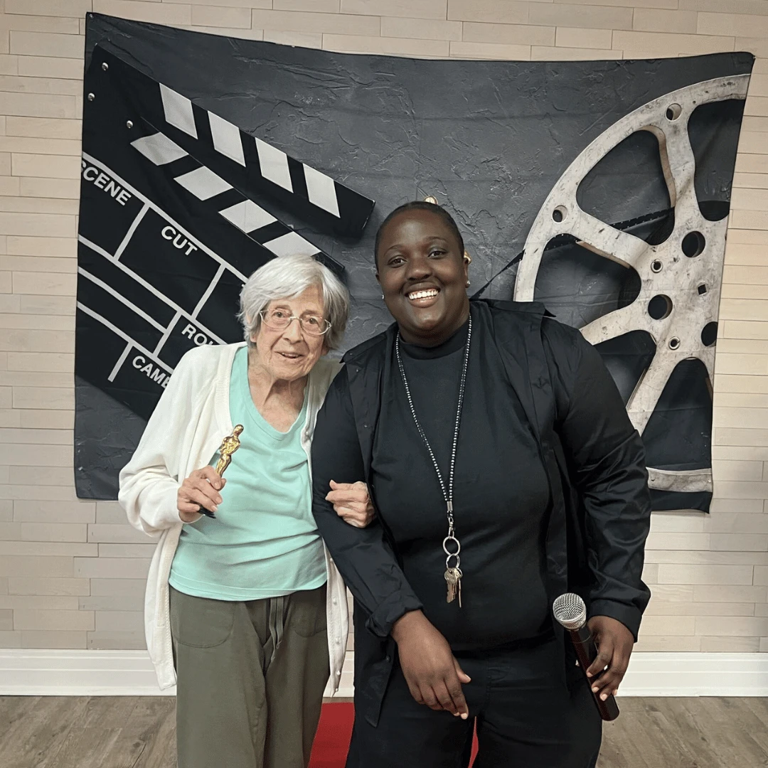 Resident and team member at The Bristal at Westbury pose for pictures after accepting Oscars