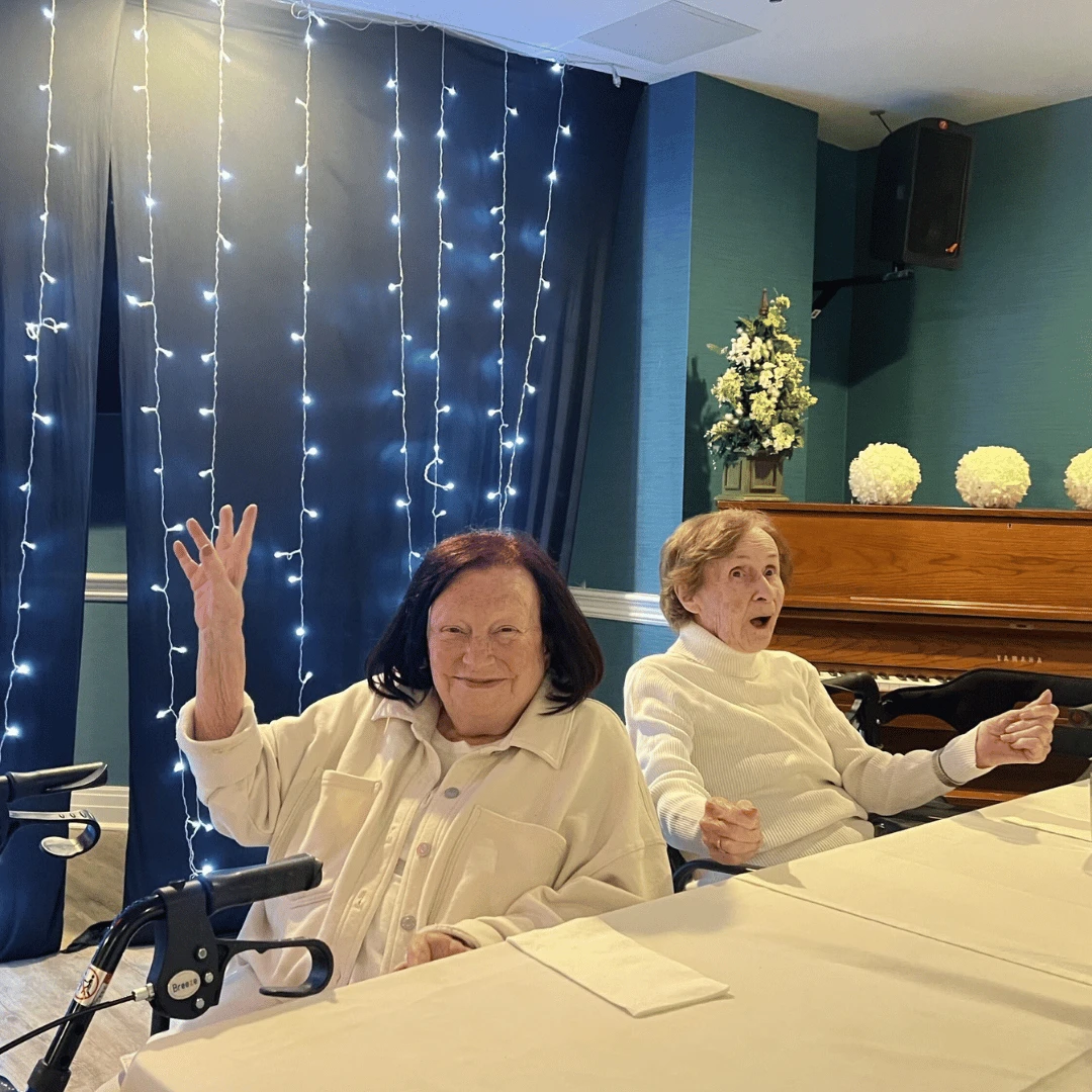 Residents pose and smile dressed in their summer white attire