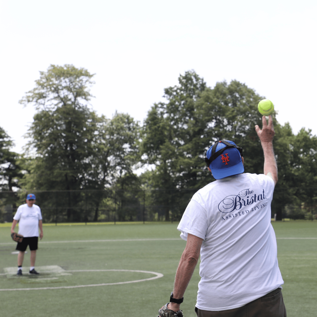 2 players warm up before the The Bristal All Stars Senior Softball Game