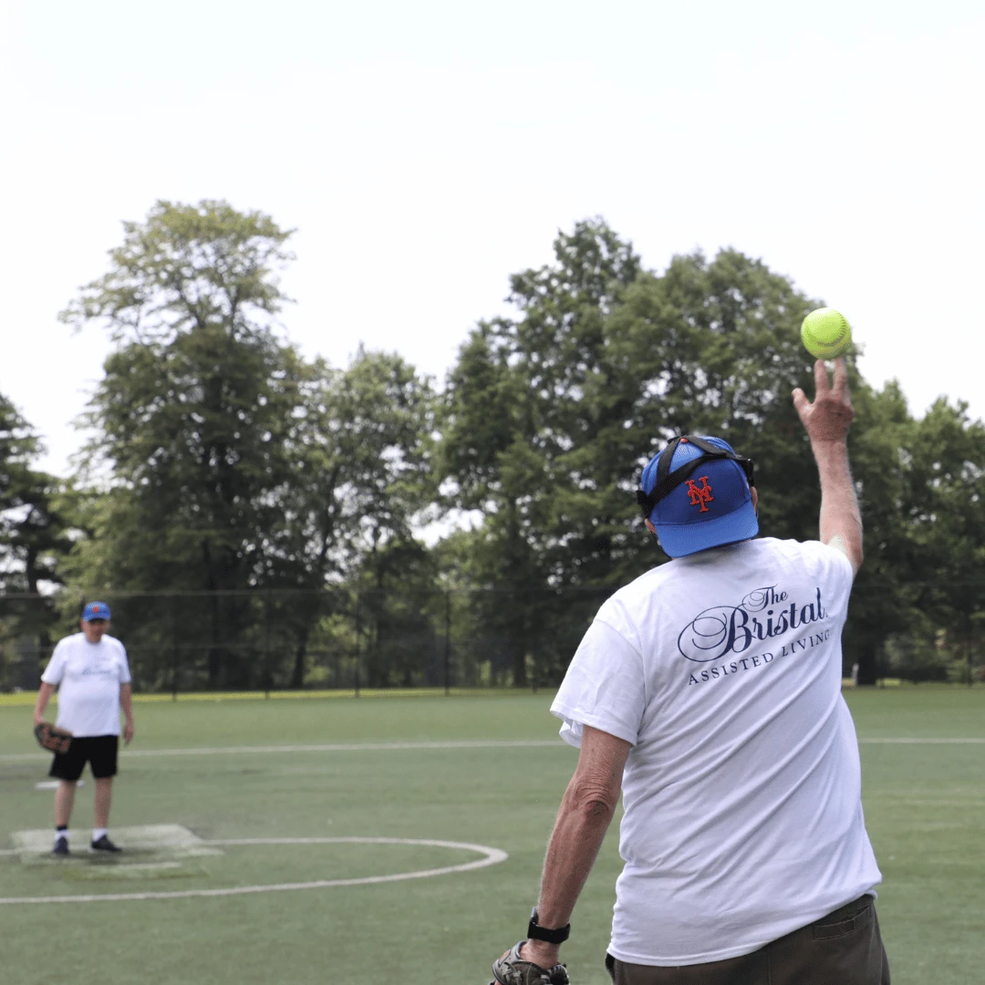 2 players warm up before the The Bristal All Stars Senior Softball Game
