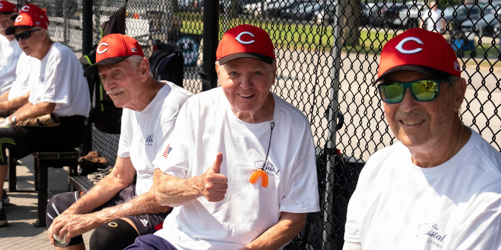The Bristal All-Stars 2026 Senior Softball: Reds players on their bench