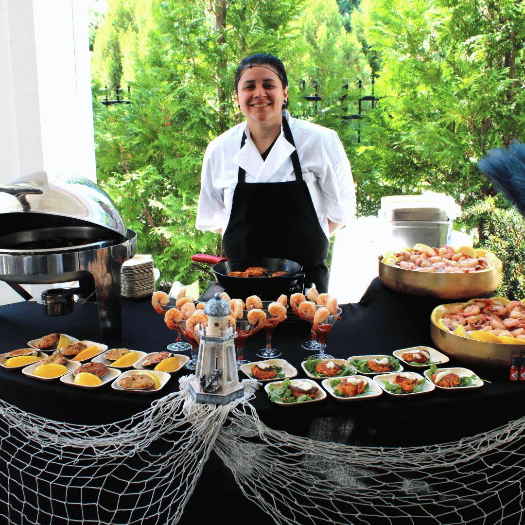 Team Member at The Bristal at Mount Sinai serves lobster at the annual summer white party 