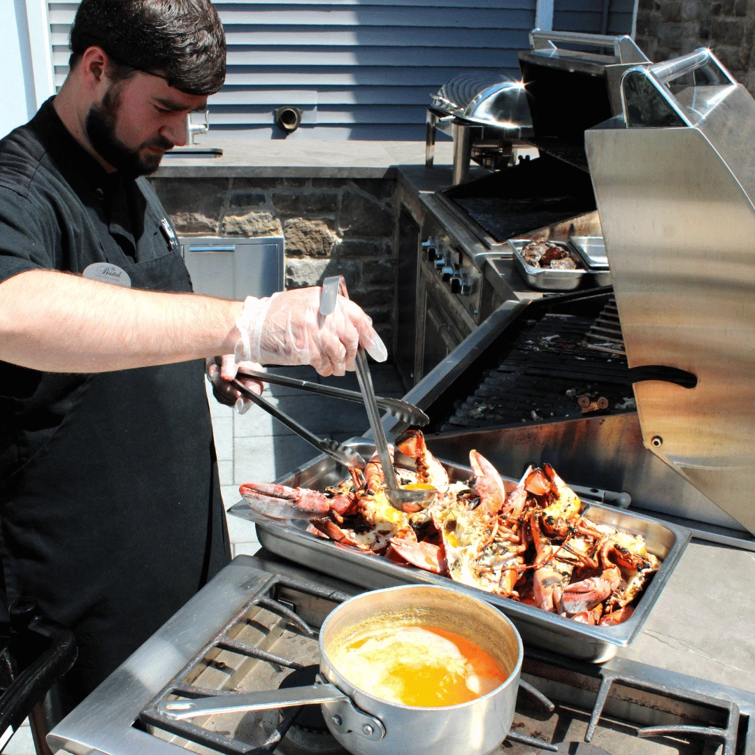 Team member at The Bristal at Mount SInai prepares the resident-favorite Lobster Bake