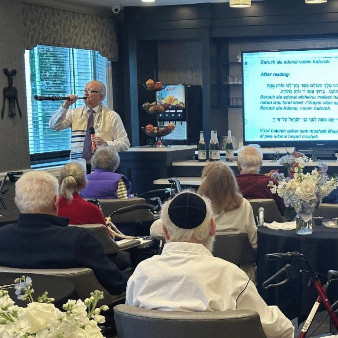 Residents of The Bristal attend a service for Rosh Hashanah as the shofar is blown