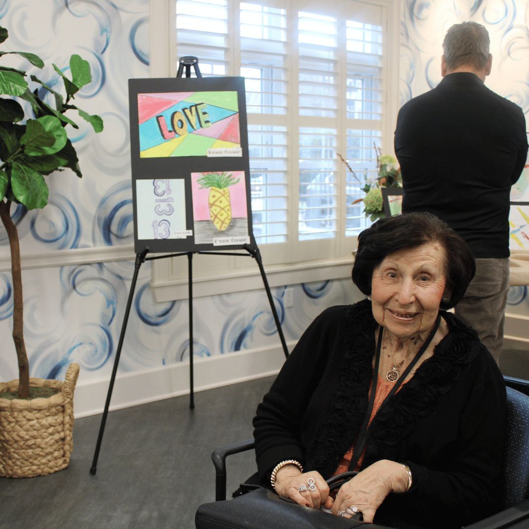 Resident at The Bristal at Jericho poses with her art work