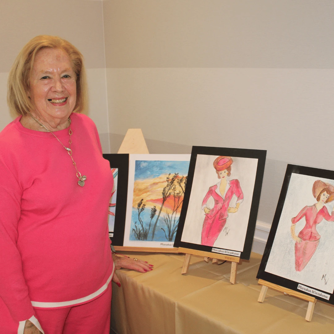 Resident at The Bristal at Jericho poses with her art work