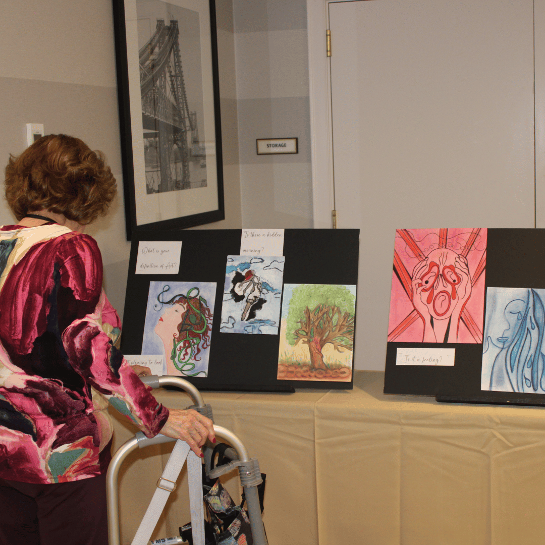 Jericho resident stops to admire art work by neighbors at The Bristal at Jericho