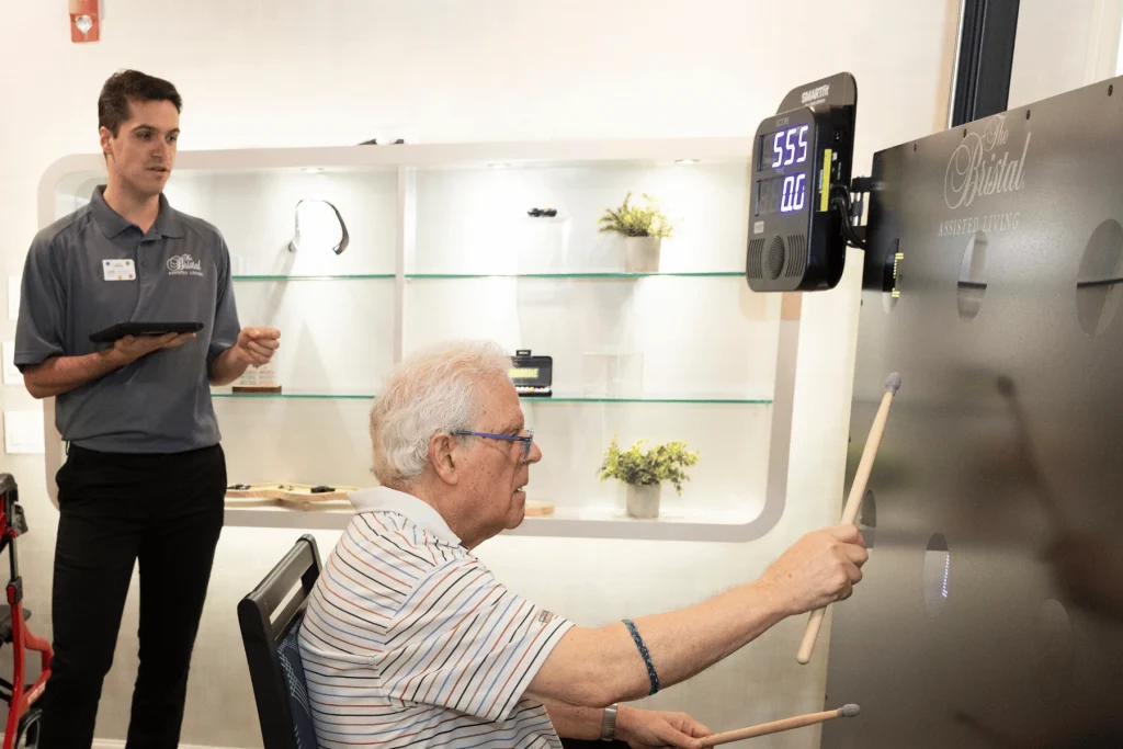 Resident of The Bristal at York Avenue demonstrates the SmartFit technology in the BrainFit Gym with team member