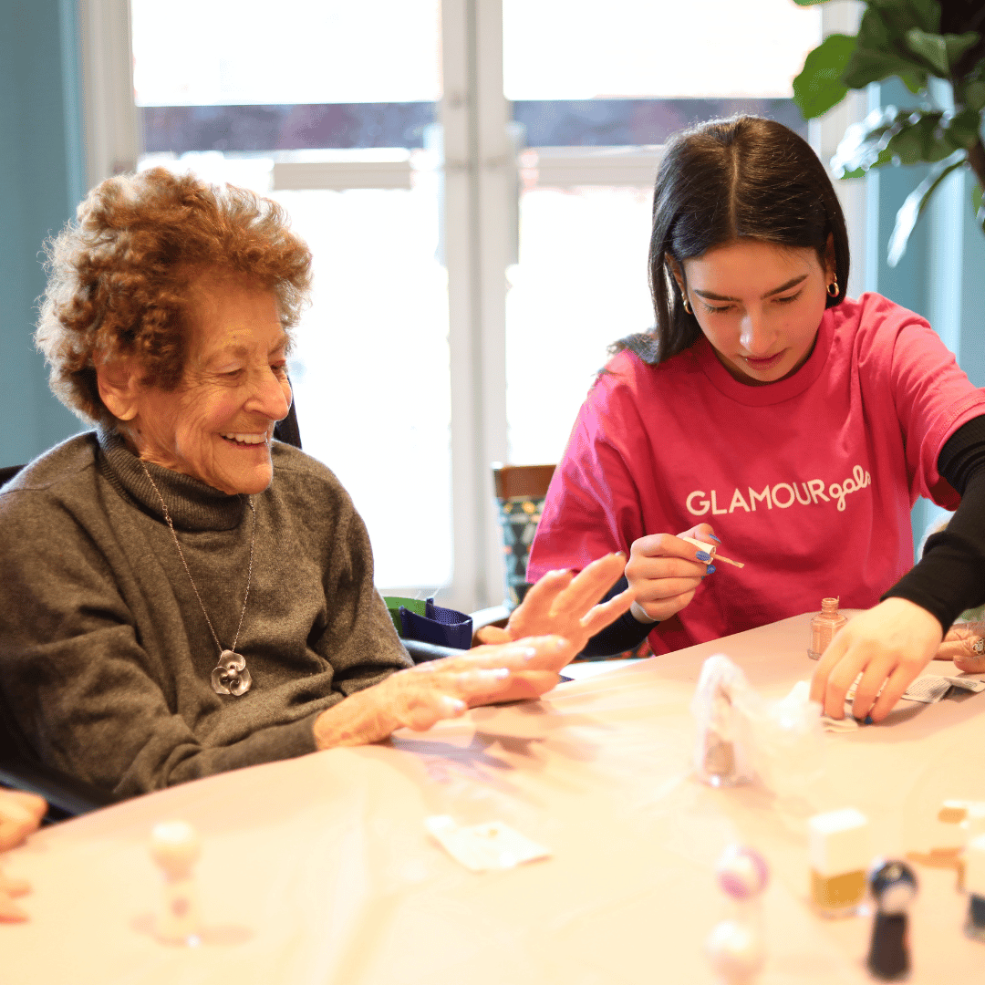 One high school aged volunteer provides a manicure makeover for a resident of The Bristal at East Meadow