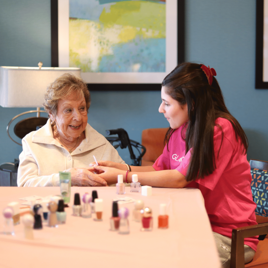 GlamourGals volunteer and resident of The Bristal at East Meadow spend quality time together