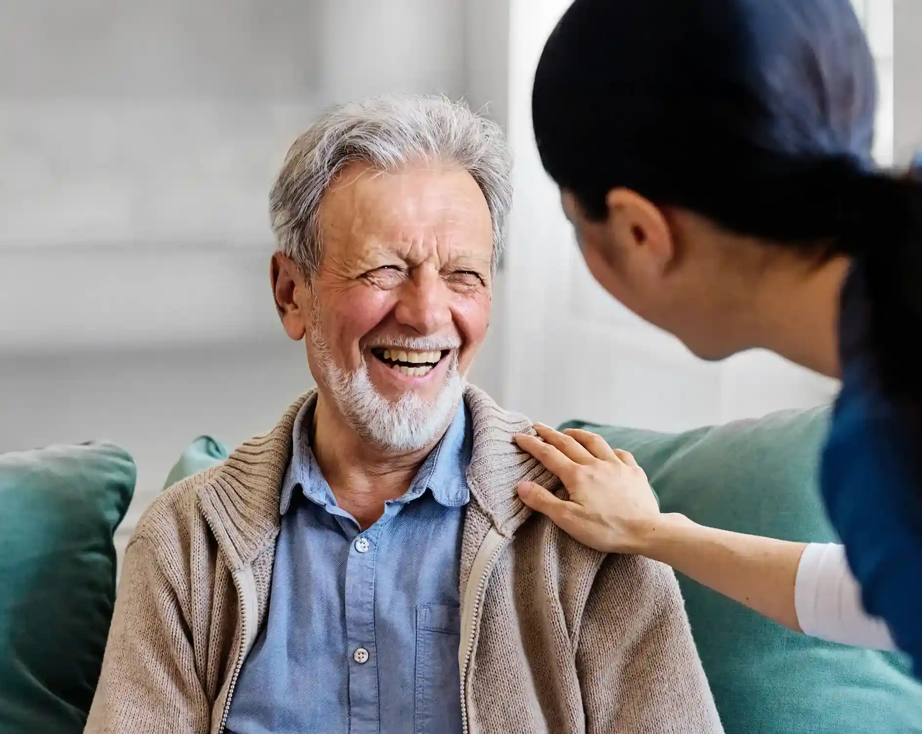 The Bristal Assisted Living - Senior resident smiling as a team member of The Bristal assisted him with personal care