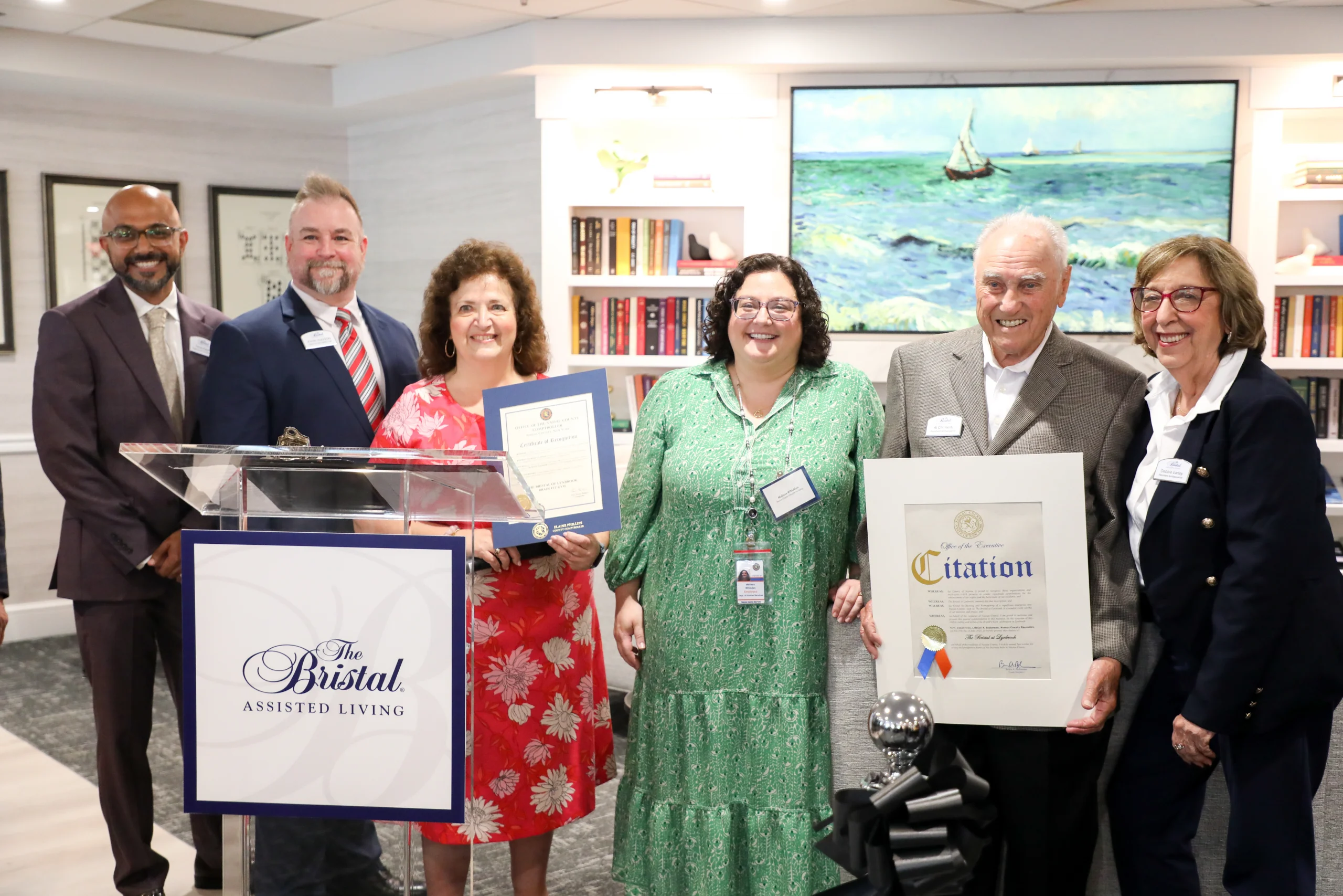 Leadership from The Bristal at Lynbrook accept an award alongside invited residents and guests