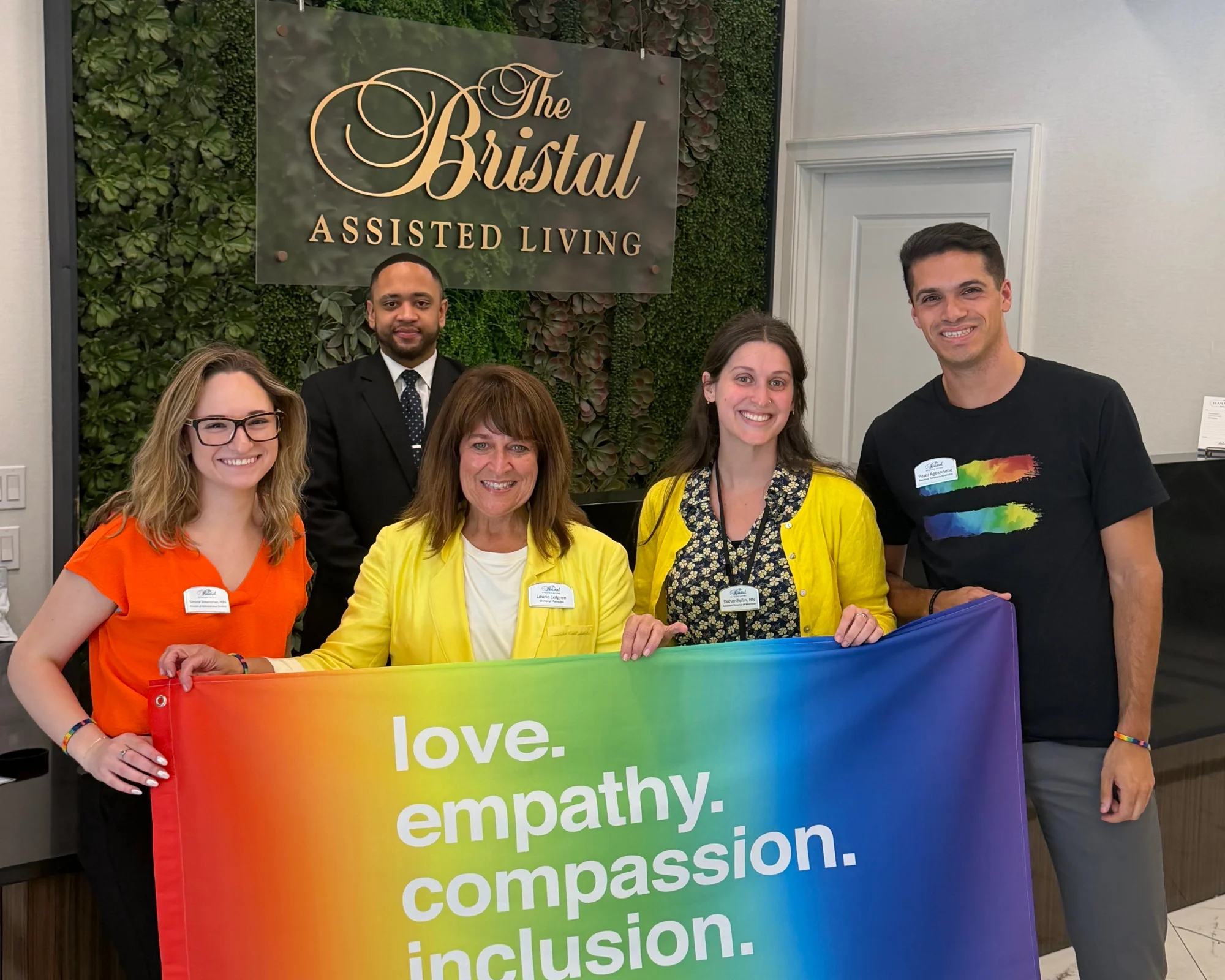 Leadership from The Bristal at York Avenue display a Pride Banner