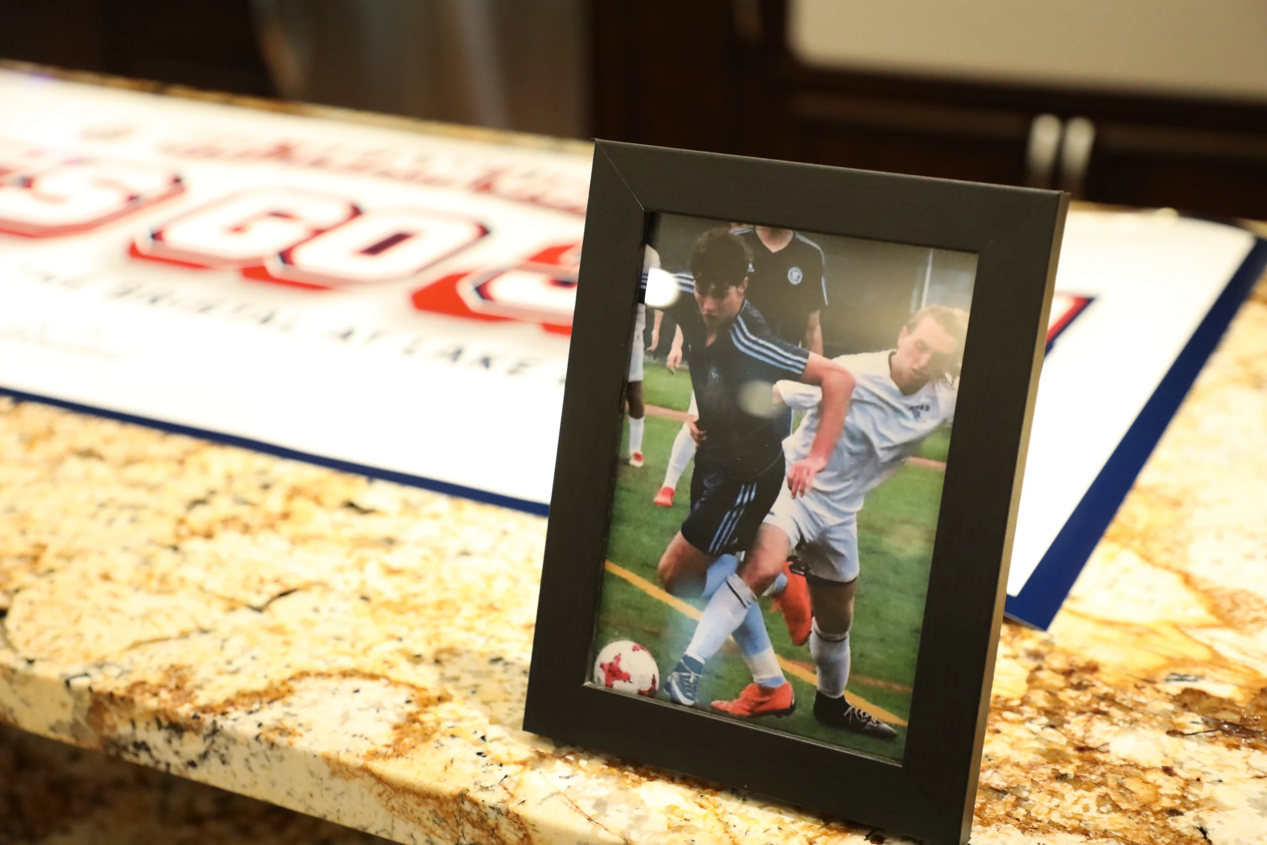 Photo of Joe Scally and Presenter Dan Giorgi displayed at The Bristal at Lake Grove during the FIFA World Cup Watch Party