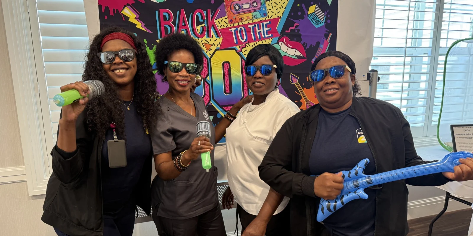 The Bristal at Sayville - Team Member Appreciation Week -Team Members dress and hold props for the 80s theme
