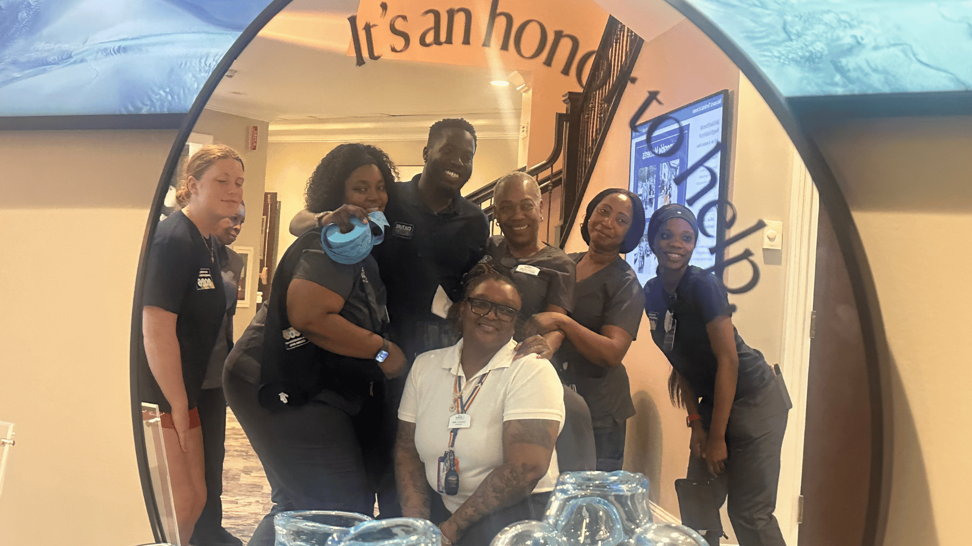 Team Member Appreciation Week at The Bristal at Armonk - Team members pose in front of a mirror with the tagline It's an Honor to Help
